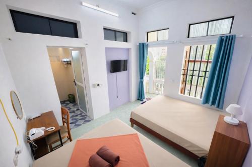 a room with a bed and a table and a window at An house Ninh Binh in Ninh Binh