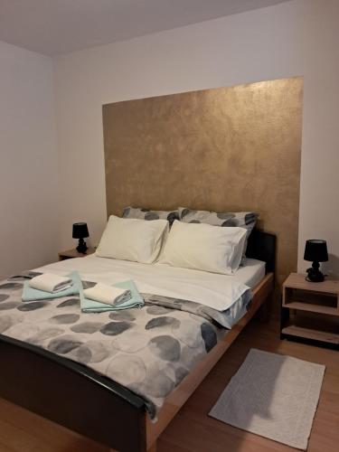 a large bed in a bedroom with two lamps at Holiday Home Manuela in Fažana