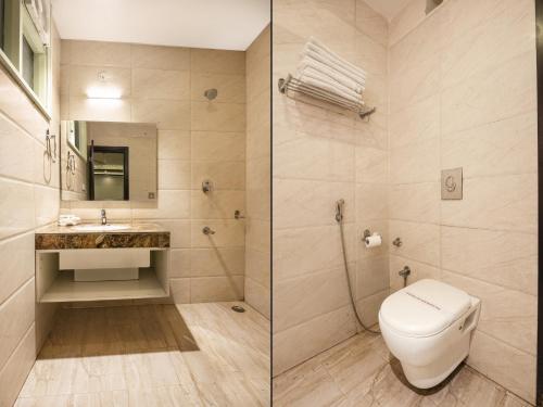 a bathroom with a toilet and a sink at Hotel The Royal Krishna in Katra