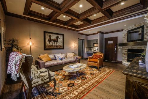 a living room with a couch and a fireplace at Hyatt Place Fort Worth Stockyard in Fort Worth