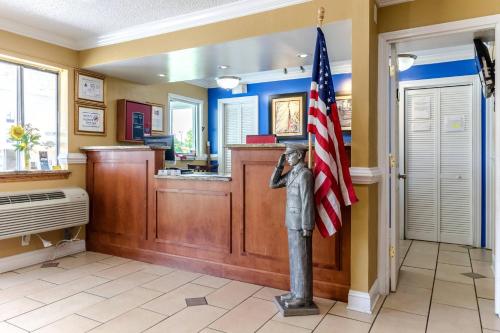 a restaurant with a statue of a man holding an american flag at Rodeway Inn & Suites Jacksonville near Camp Lejeune in Jacksonville