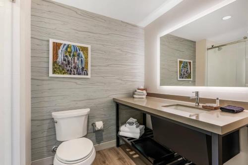 a bathroom with a toilet and a sink at Cambria Hotel Portland - Pearl District in Portland