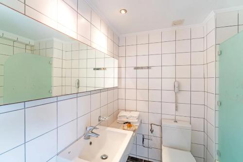 a bathroom with a sink and a toilet at Cathrin Hotel Rhodes By Anayia All Inclusive Resorts in Faliraki