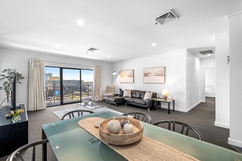 a living room with a table and a couch at Barrack Street City Pad 2br 2 Bth in Perth