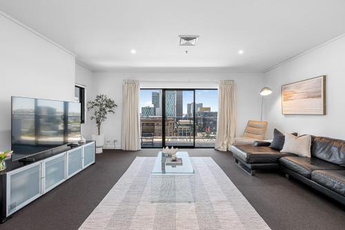 a living room with a couch and a tv at Barrack Street City Pad 2br 2 Bth in Perth