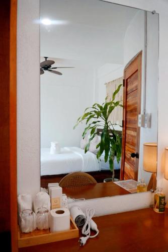 a bedroom with a bed and a mirror at Who's Gloria in El Nido