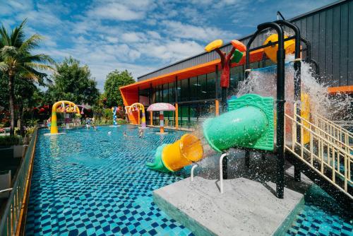 a pool with a water park with a water slide at Love Rawai Hotel in Rawai Beach