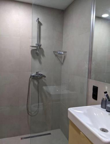 a bathroom with a shower and a sink at Koktha-Mitarbi Resort Block 1 Appt 215 in Bakuriani
