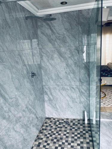 a shower with a glass door in a bathroom at Euphoria Escape in Midrand