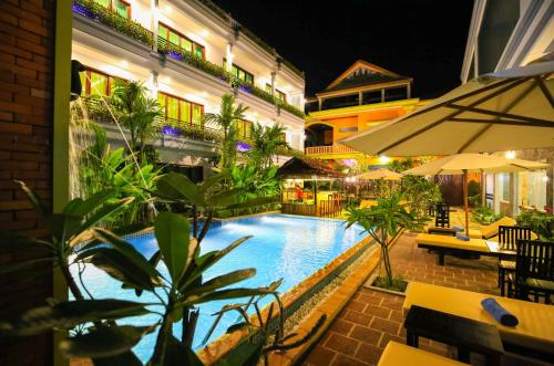 a swimming pool at a hotel at night at Chheng Residence in Siem Reap
