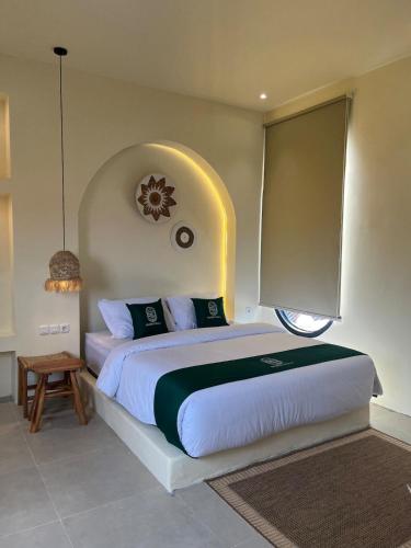 a bedroom with a large bed with an arched ceiling at Sampai Villa Kama in Ngaglik