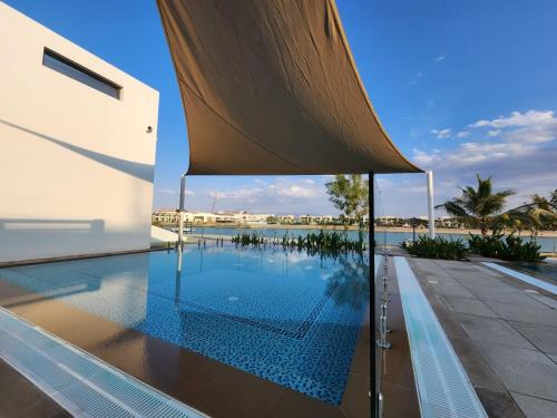 a swimming pool in the middle of a house at Nasma Luxury Stays - Opulent family escape in coastal community in Ras al Khaimah