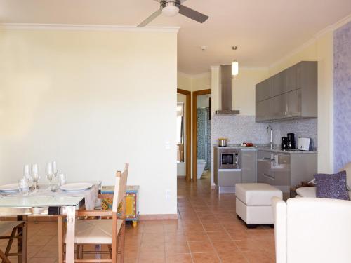 a kitchen and living room with a table and a dining room at Idyll Suites - Adults Only in Playa del Cura