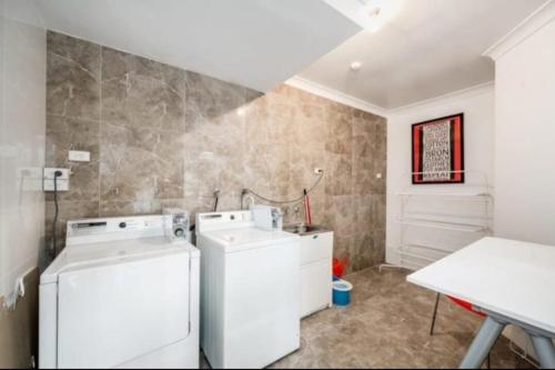 a laundry room with a washer and dryer at Number 4 Smugglers Inn in Victor Harbor