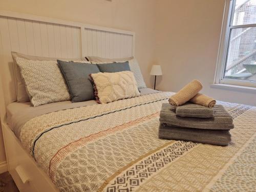 a bedroom with a large bed with two pillows on it at Number 4 Smugglers Inn in Victor Harbor