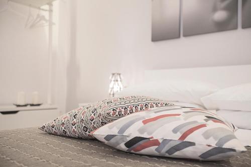 two pillows sitting on a bed in a room at Excelsior in Piombino