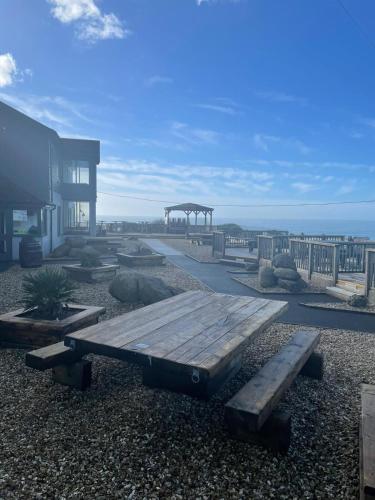 a wooden bench sitting in front of a building at Widemouth Manor Hotel in Bude