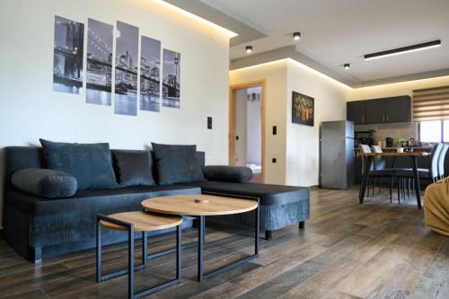 a living room with a blue couch and a table at Blue Horizon in Sevastí