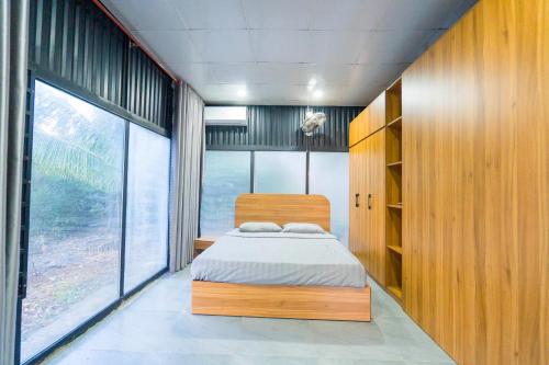 a bedroom with a bed and a large window at Vân Hòa Phú Yên homestay highland in Tuy Hoa