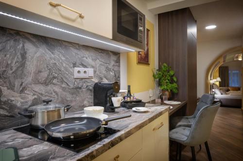 a kitchen with a counter top with a stove top at Kaiserstein Palace Apartments in Prague