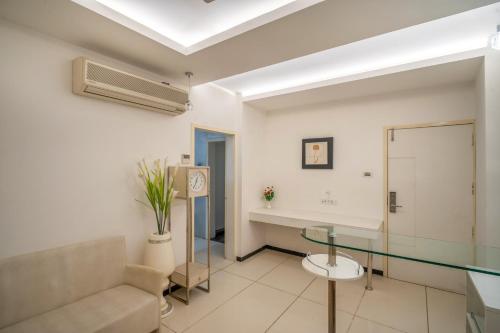 a living room with a glass table and a couch at Hotel Varun in Guna
