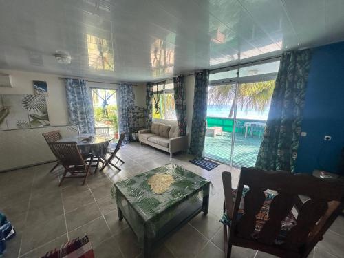 a living room with a couch and a table at Eli Beach House in Vaiorea