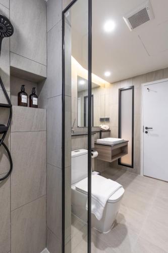 a bathroom with a toilet and a sink at Holmes Pranakorn in Bangkok