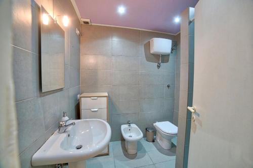 a bathroom with a sink and a toilet at Orange Home in Olbia
