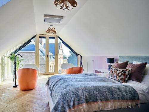 a bedroom with a bed and a large window at Finest Retreats - Sea Gables in Exmouth