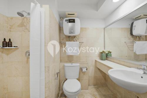 a bathroom with a toilet and a sink at Tanea by Kozystay - Braga in Bandung