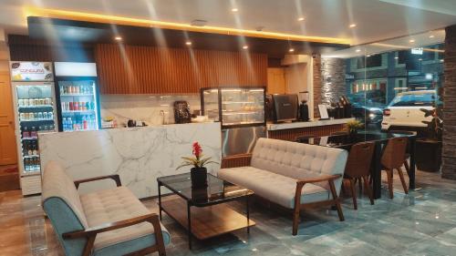 a restaurant with chairs and a table and a counter at SVJ Hotel in Cebu City