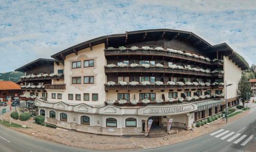 a large building on the side of a street at Das Walchsee Resort in Walchsee