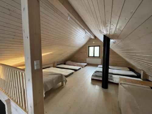 a room with three beds in a attic at Sikana Mõisa saun in Sikana