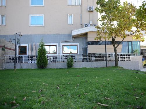 a house with a fence and a tree in a yard at Samsun Airport Resort Hotel in Samsun