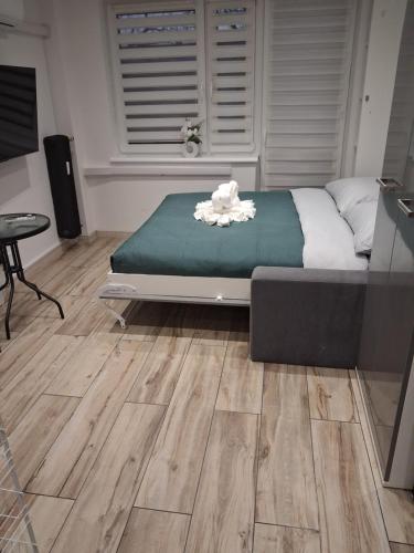 a bedroom with a bed and a table and a window at Sikalafo in Płock
