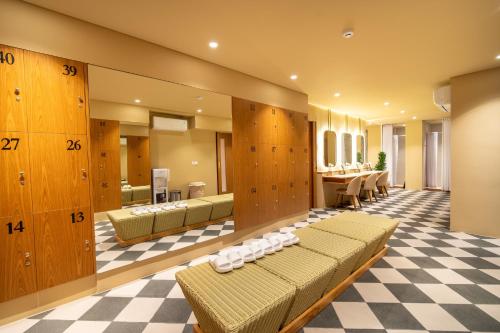 a room with couches and a checkerboard floor at TS SUITES Seminyak Bali in Legian