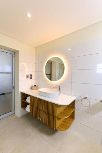 a bathroom with a sink and a mirror at Oyster Box Guesthouse in Walvis Bay