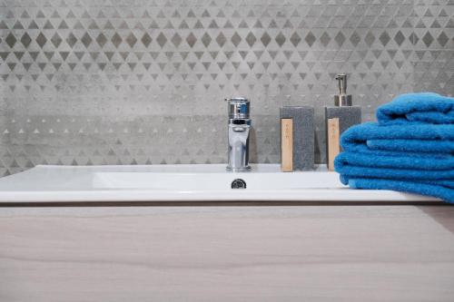 a bathroom sink with a faucet and a towel at B&B a due passi dal centro in Castelsardo