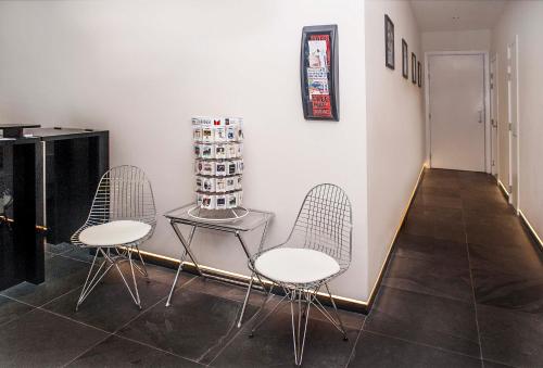 two chairs and a table in a room at NOX Belsize Park in London