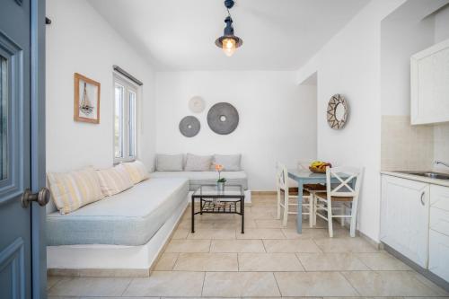 a living room with a couch and a table at Indigo Studios in Livadi
