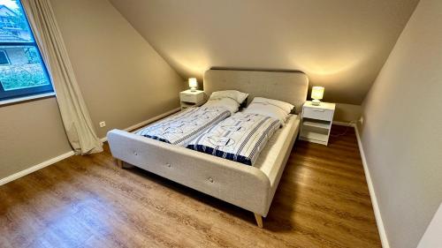 a small bedroom with a bed with two night stands at Fewo Ostseetraum Laboe in Laboe