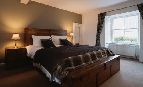 a bedroom with a large bed and a window at The Newport Inn in Newport-On-Tay