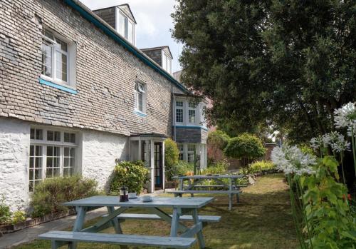 a picnic table in front of a building at 1605 by the sea in Falmouth