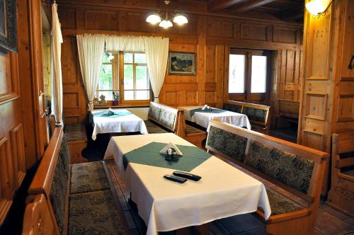 a dining room with two tables and chairs at Penzion Diana in Teplice nad Bečvou