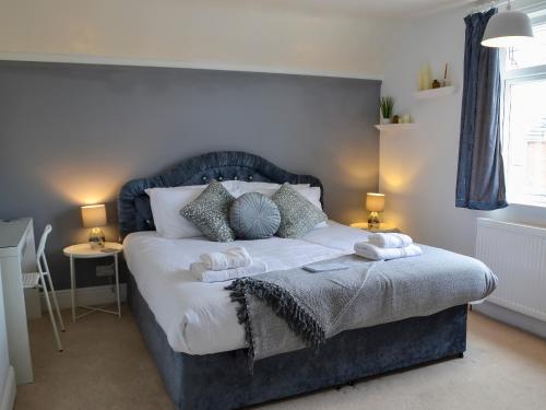 a bedroom with a bed with two pillows on it at Nala's Cottage in Skegness
