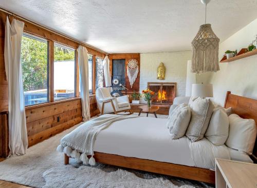 a bedroom with a large bed and a fireplace at Enchanted Waterfall Sanctuary in Mill Valley