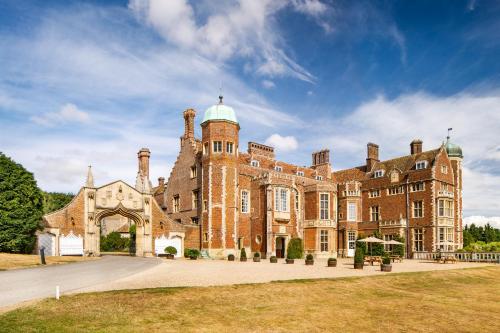 a large brick building with a dome on top at Madingley Hall in Cambridge