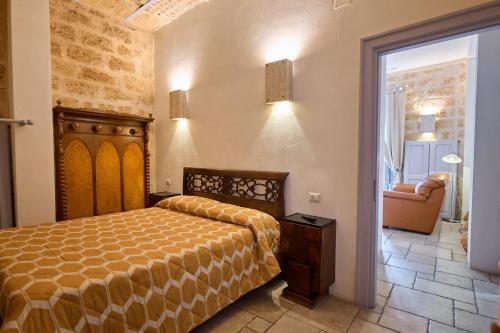 a bedroom with a bed and a chair in a room at Bed & Breakfast Casa Lopez in Barletta