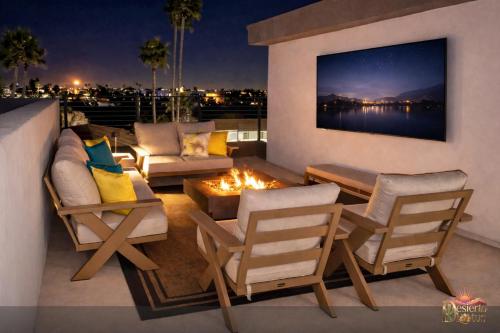 a patio with two chairs and a fire pit at Scottsdale 3BR with Private XL Rooftop, 2Car Garage, Heated Pool & Hot Tub, EV L2, 12min to Airport in Scottsdale