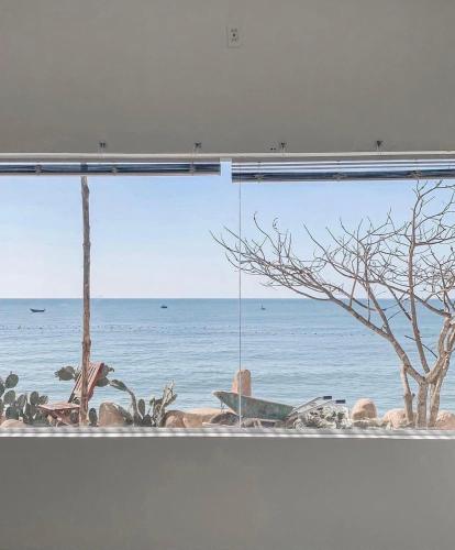 a view of the ocean from a window at 3B MAISON Homestay & Villa in Mui Ne